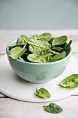 A bowl of fresh spinach leaves