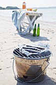Bucket barbecue and folding table on beach