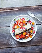 Cheesecake with fresh fruit and icing sugar
