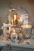 Sparkling silver arrangement of candles, tealight holders and silvered glass