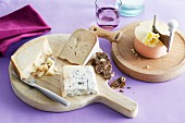 A cheese platter with drinks and fruit bread