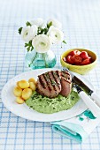 Grilled veal medallions in herb sauce with potatoes