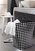 Black and white laundry bag below washstand