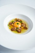 Prime boiled beef broth with egg, garlic bread and lovage