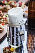 Jar with a whistle as a napkin holder