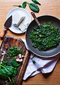 Steamed spinach with ricotta and garlic being made