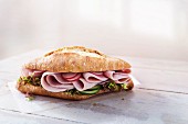Ciabatta roll with ham, radishes, cucumber and lettuce