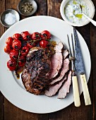 Roast beef with cherry tomatoes and mint and garlic yoghurt