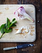 Garlic, sea salt and mint leaves on a wooden chopping board