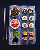 A sushi platter with wasabi, pickled ginger and salad