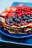Pancake cake with jam and fresh berries