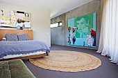 Open bedroom with large, modern picture on concrete wall