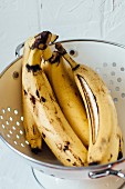Overripe bananas in a colander
