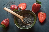 Chia seeds and strawberries on a slate platter