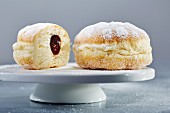Doughnuts with icing sugar and ham, whole and halved