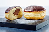 Nougat doughnuts with chocolate glaze, whole and halved