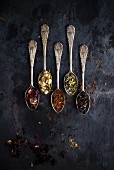 Various types of tea on five vintage spoons (seen from above)