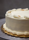 A whole layer cake with buttercream and caramel dots