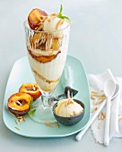 A caramelised peach ice cream sundae with flaked almonds