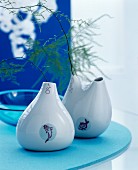 Blue arrangement with teardrop vases decorated with fish motifs