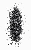 A pile of black vulcan salt on a black surface