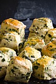 Freshly baked scones with herbs on a baking tray