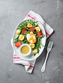 Warm salad with poached eggs