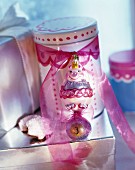 Tin decorated with pink ribbon and original Christmas tree bauble