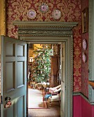 View into festive living room through antique door