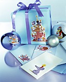Arrangement of envelopes, baubles and wrapped gift decorated with cartoon motifs