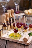 Cheese appetizers with grapes on a wooden chopping board