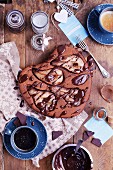 Pear and chocolate cake with coffee on a wooden table