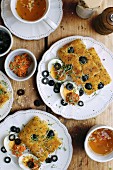 Gluten-free focaccia with black olives on a white plate