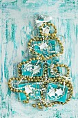 Turquoise boxes and strings of beads arranged in the shape of a Christmas tree