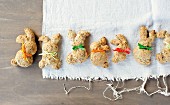 Crispy bread rabbits made from spelt dough decorated with bows for Easter