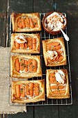 Puff pastry slices with ham, cream cheese, mini carrots and yoghurt sauce