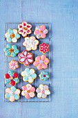 Flower-shaped carrot cookies with colourful sugar glaze