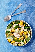 Spinach salad with baked chicken breast, cucumber, mango and sunflower seeds