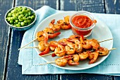 Shrimp kebabs with tomato salsa and green peas