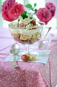 A trifle with red gooseberries and homemade almond biscuits
