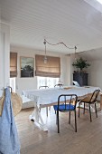 Simple dining room decorated with linen fabrics in natural shades