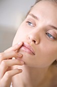 Woman applying lip balm