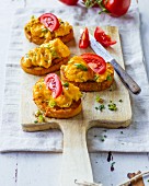 Spring scrambled egg with chives on a tomato baguette