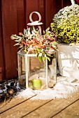 Candle lantern decorated with twigs and berries