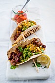 Tacos with vindaloo beans, avocado and sweetcorn