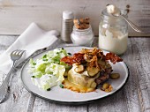Gratinated burger with cornichons, bacon and roasted onions