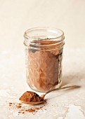 Cocoa powder in a jar and spoon