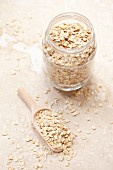 Oats in a jar and on a wooden scoop