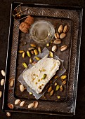 A slice of Delice de Bourgogne soft cheese served with pistachio nuts and champagne