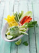 Colourful vegetables sticks with an avocado and yoghurt dip